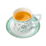 Ornate white teacup with floral pattern, filled with amber tea, on mint green saucer.